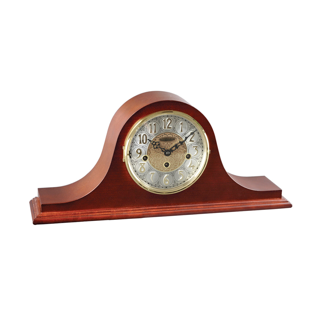 Cherry wood mantel clock with ornate hands on white background.