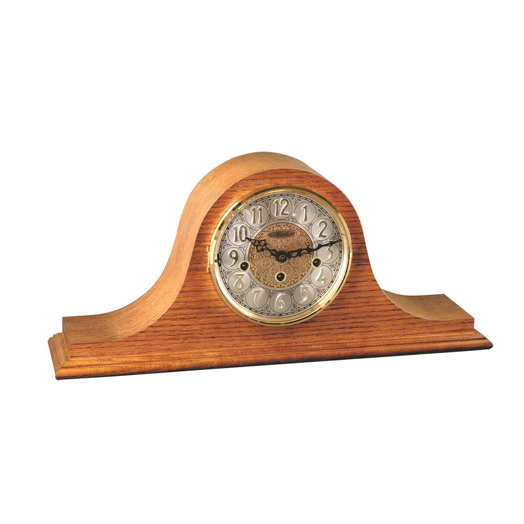 Light oak wood mantel clock with ornate hands on white background.