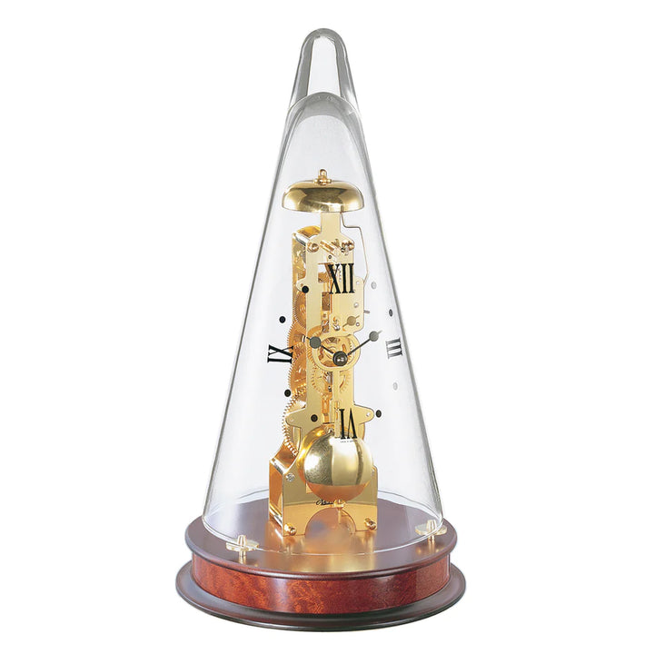 Conical mechanical clock with brass gearing visible beneath glass dome, sitting on mahogany wood base