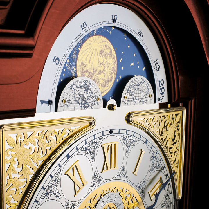 Up close of ornate clock face with detailed moon phase dial.