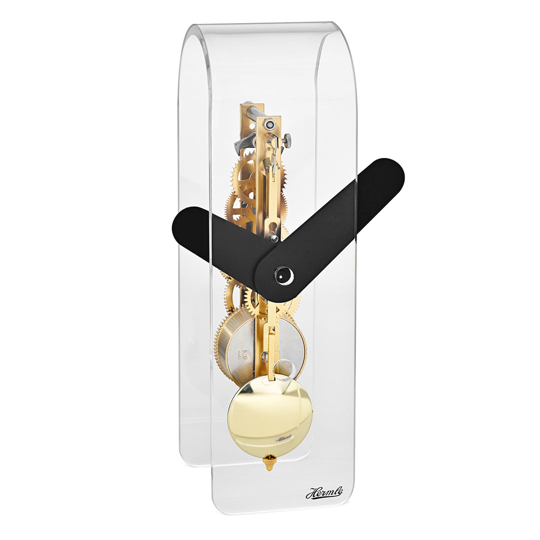Clear desk clock with visible brass gearing inside and black hands