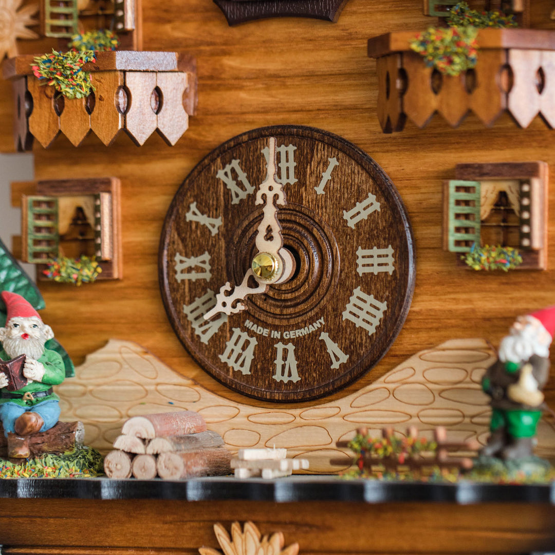 Close up of wooden cuckoo clock face with words 'Made In Germany' and two gnomes