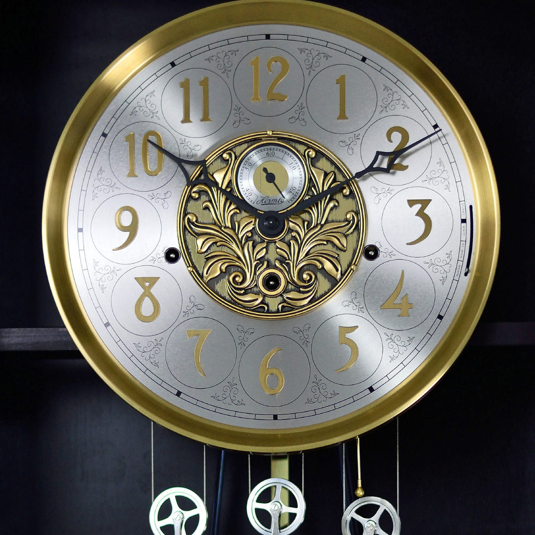 Up close of brass and brushed nickel grandfather clock face with seconds display