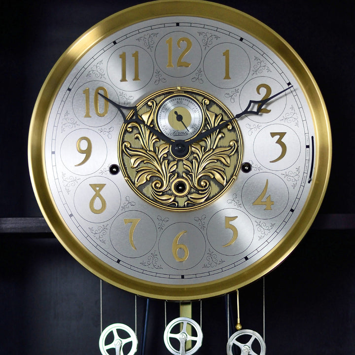 Up close of brass and brushed nickel grandfather clock face with seconds display