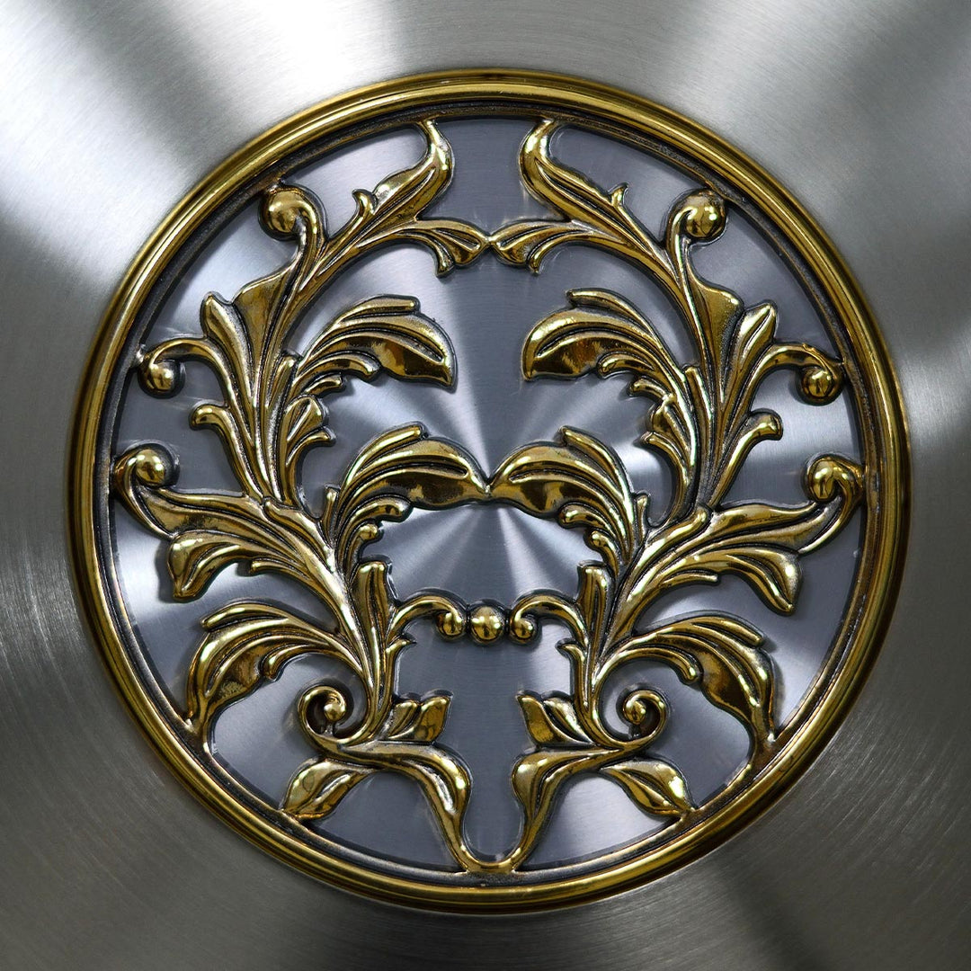 Up close of intricate brass detail on nickel grandfather clock pendulum