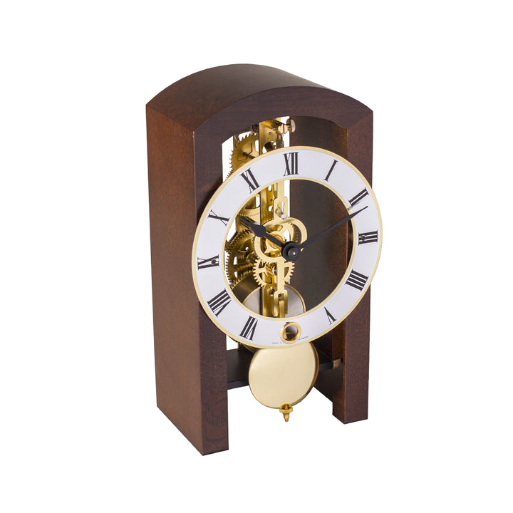 Mechanical clock with walnut casing and silver face highlighted by brass on a white background