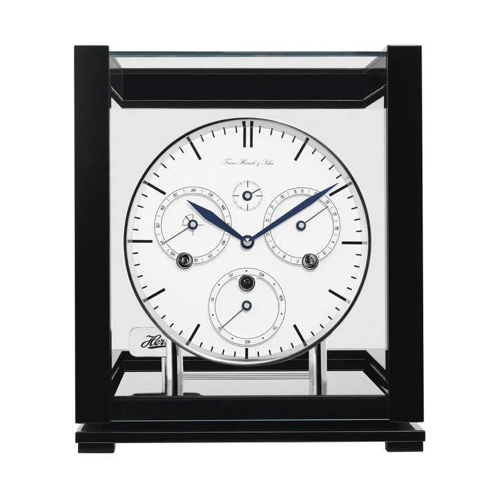Front view of black perpetual calendar clock with white face and silver highlights on white background.