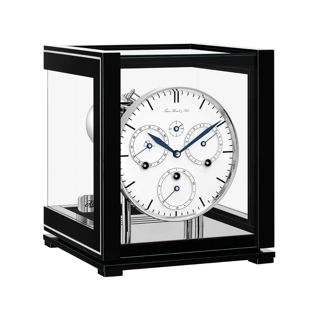 Black perpetual calendar clock with white face and silver highlights on white background.