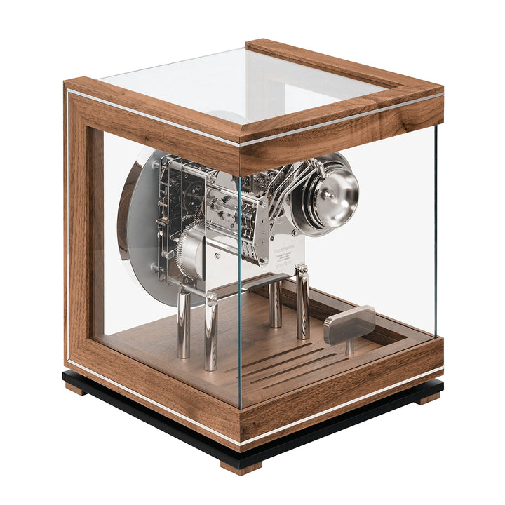 Intricate silver gears inside glass paneled walnut perpetual calendar clock.