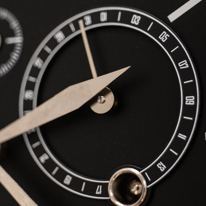Close up of black day dial on mechanical perpetual calendar clock.