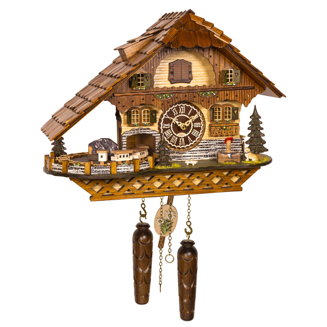 Intricate German cuckoo clock with house design and small train on one side, with roman numeral face