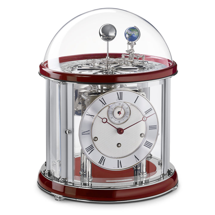 Red and nickel Tellurium clock with glass dome and nickel plated mechanical gears visible.