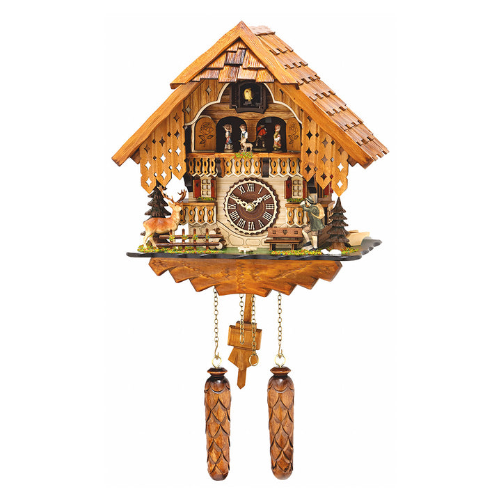 Intricate wooden cuckoo clock with wooden pendulum and figurines of deer and people next to trees 