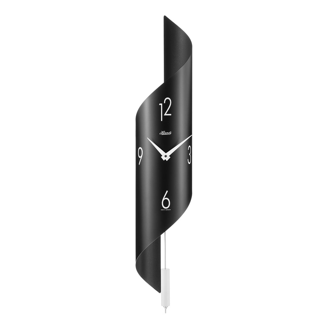 Black finish abstract clock with silver finish pendulum and arabic numerals on white background.