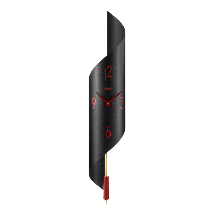 Black finish abstract clock with red finish pendulum and arabic numerals on white background.