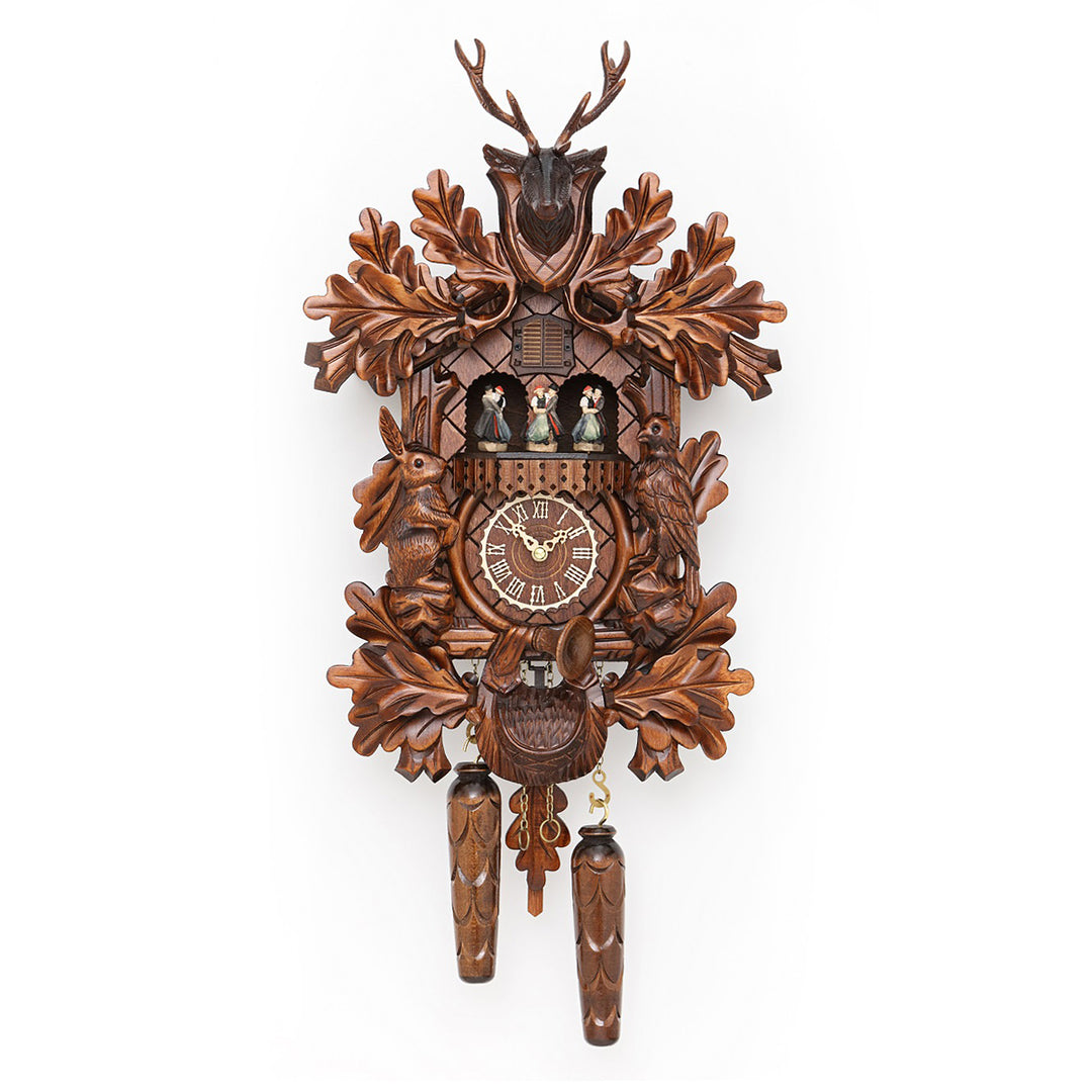 Wooden cuckoo clock with intricate carved leaves around roman numeral face
