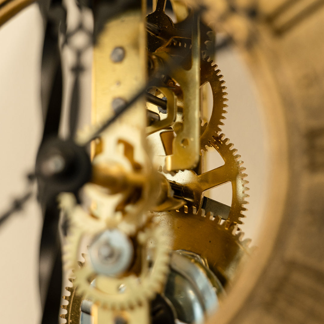 Close up of brass gears inside an antique-style skeleton clock.