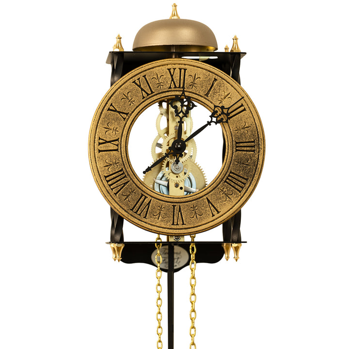 Black skeleton clock with antique-style brass face and etched roman numerals on white background.