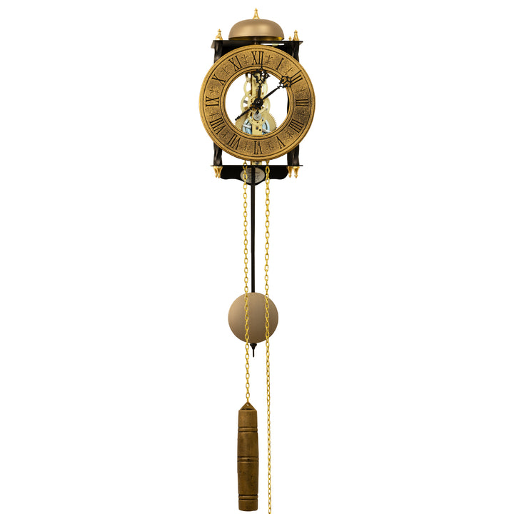 Black skeleton clock with antique-style brass face and etched roman numerals on white background with brass chains and single weight hanging down.