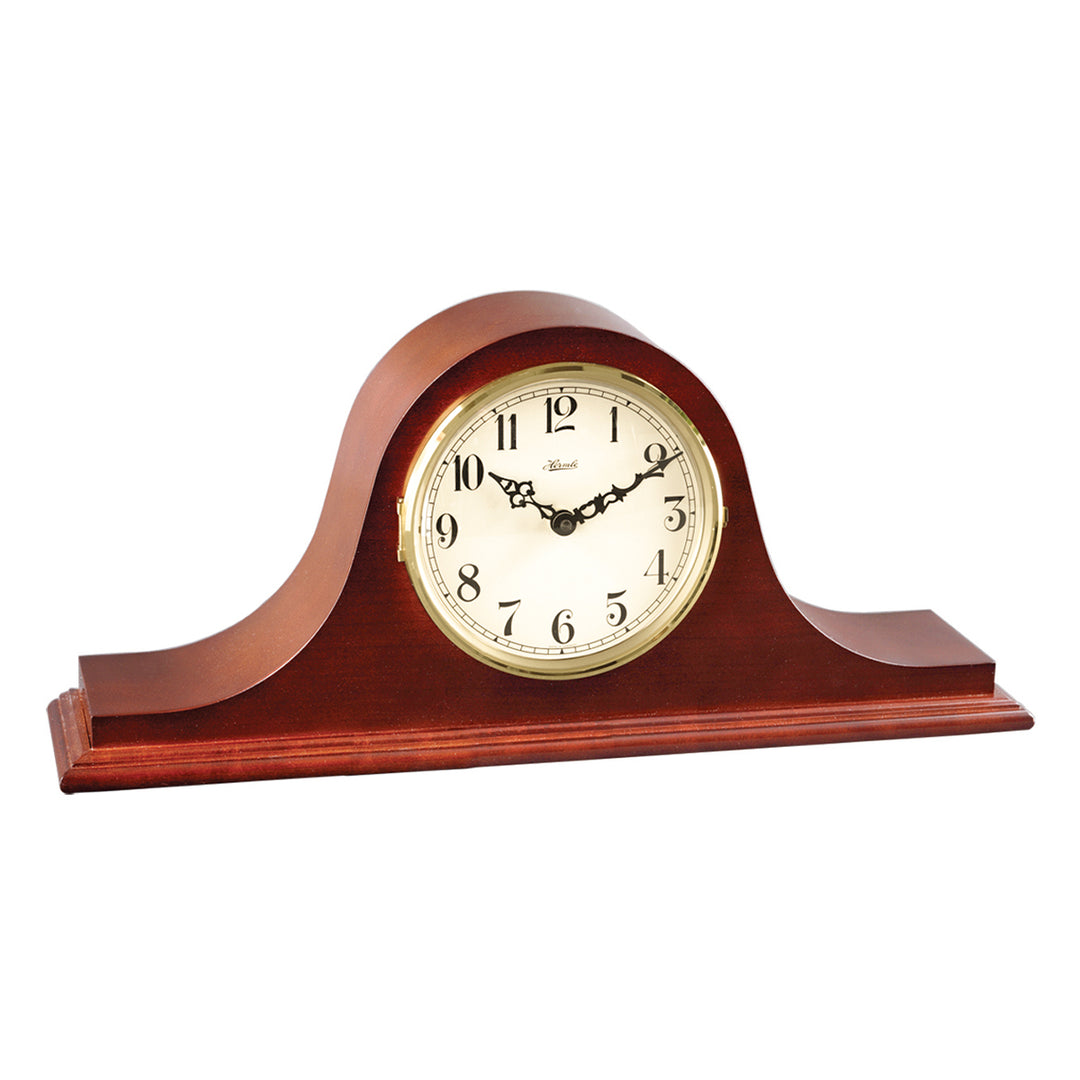 Wooden mantel clock with white face and brass highlights on a white background.