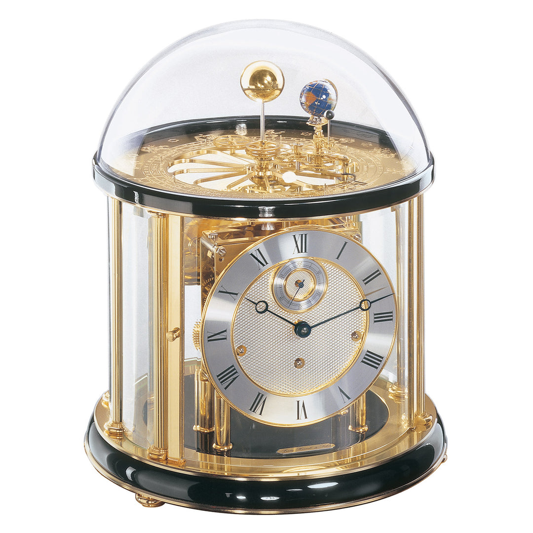 Black and brass Tellurium clock with glass dome and brass plated mechanical gears visible.