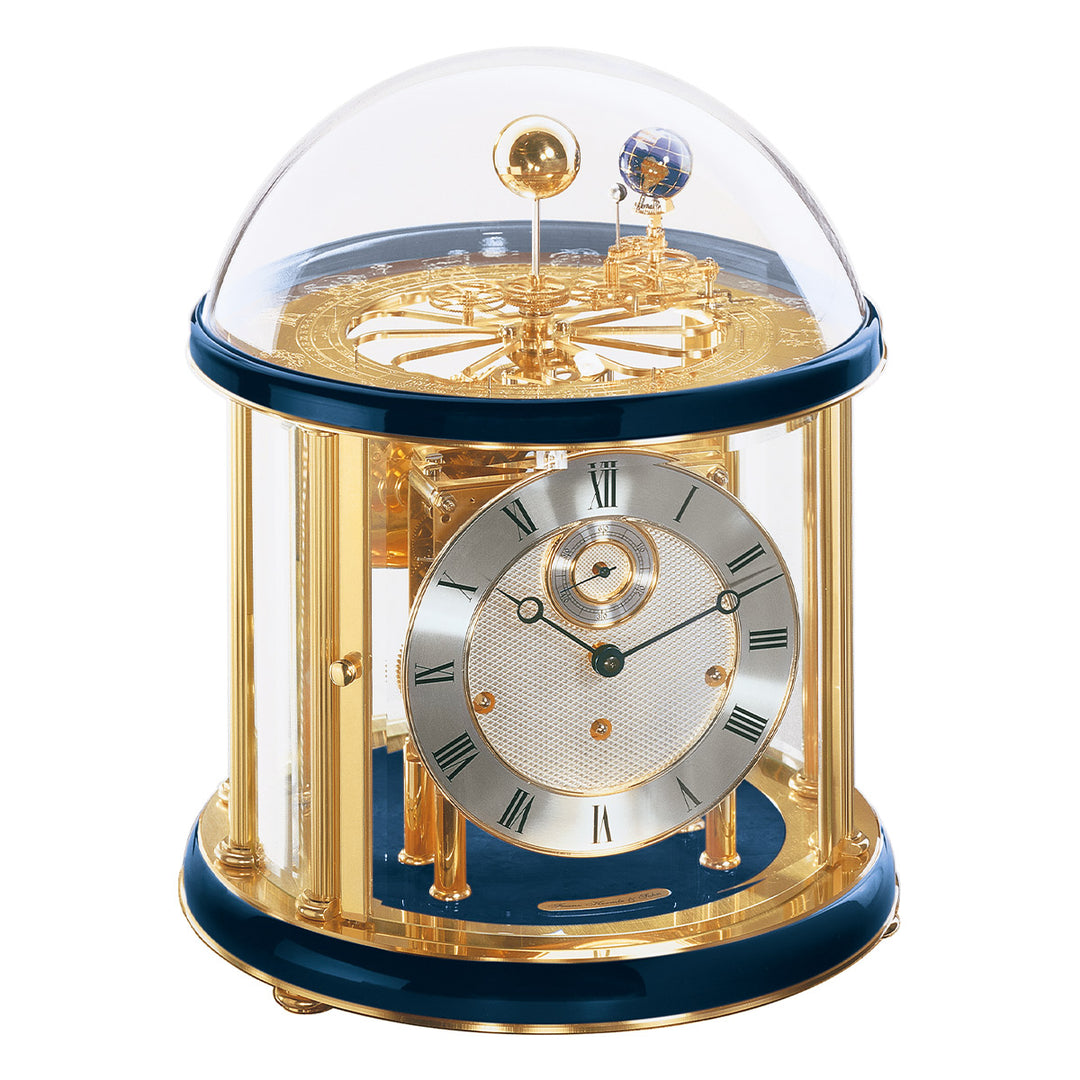 Blue and brass Tellurium clock with glass dome and brass plated mechanical gears visible.