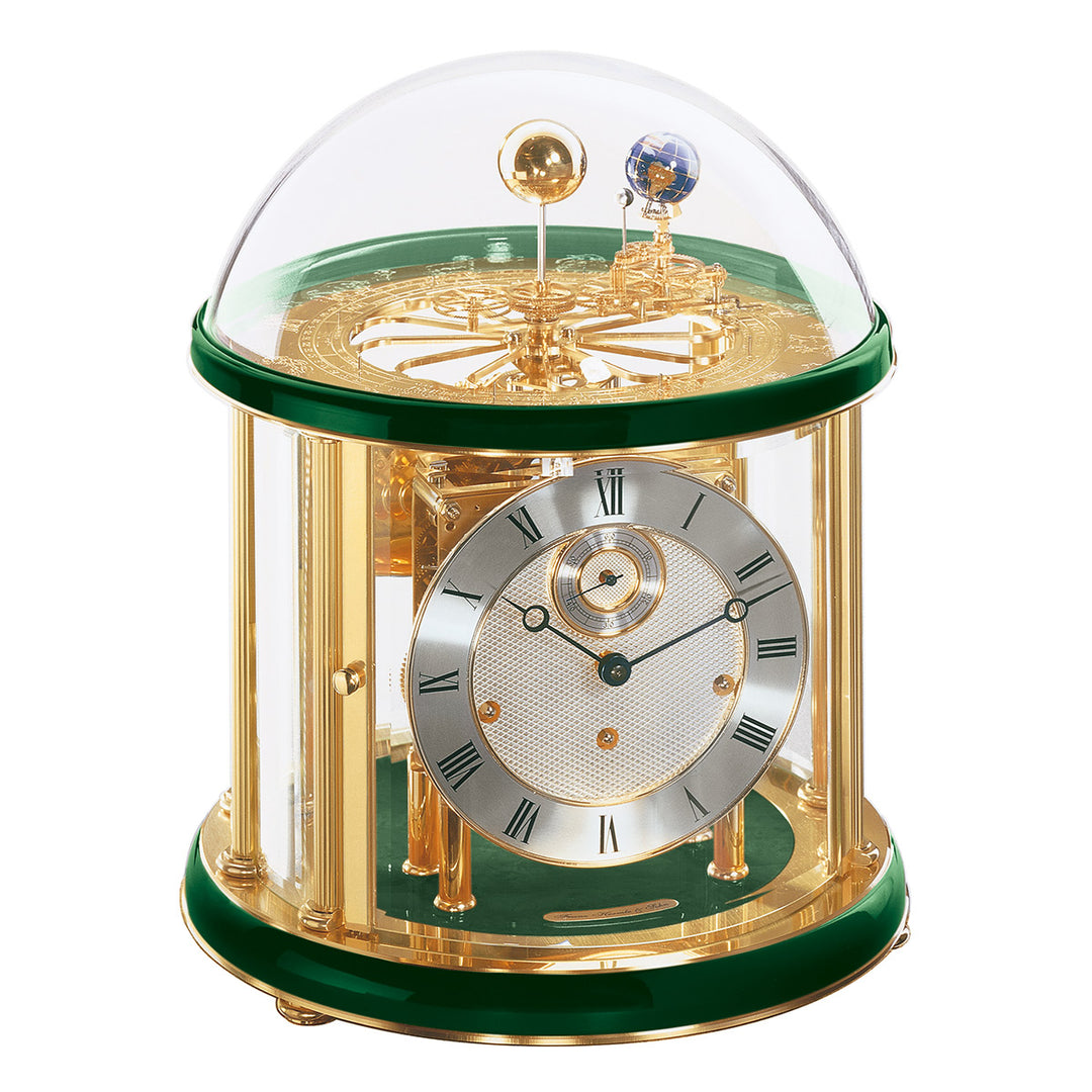 Green and brass Tellurium clock with glass dome and brass plated mechanical gears visible.