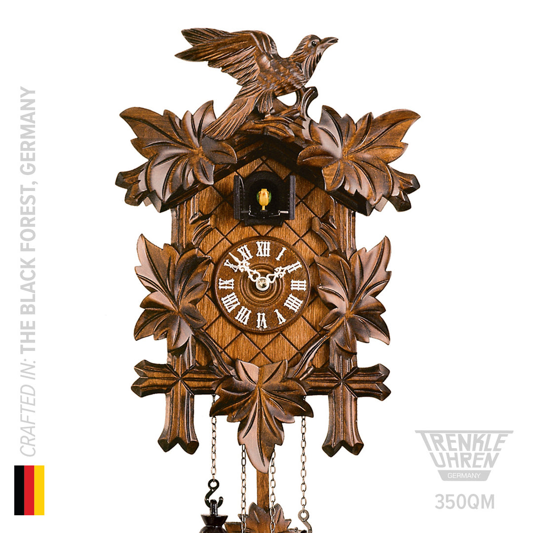 Wooden quartz cuckoo clock by Trenkle on white background