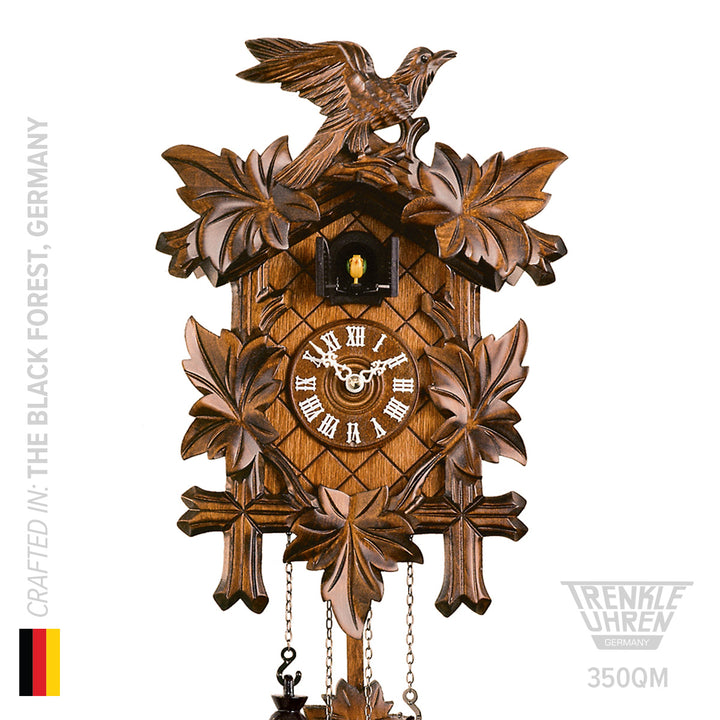 Wooden quartz cuckoo clock by Trenkle on white background