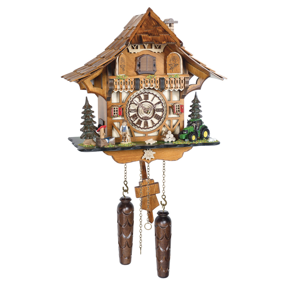 Intricate wooden cuckoo clock with pine trees and tractor detailing