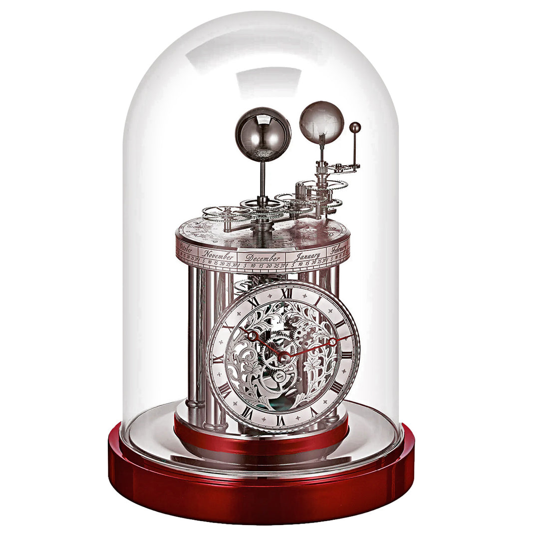 Mechanical Astrolabium clock under a glass dome on a white background