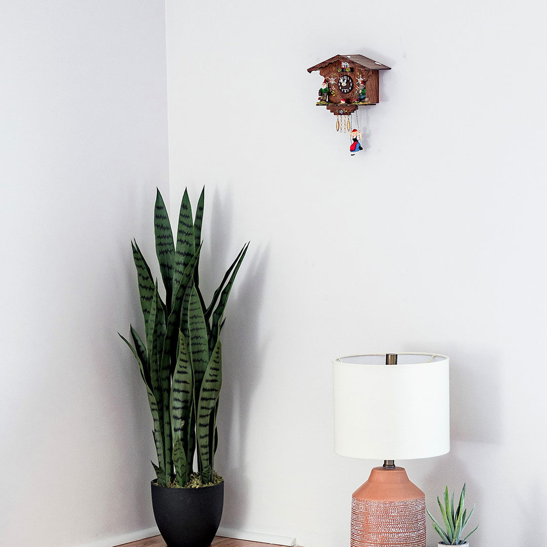 Traditional German cuckoo clock:  Annaliesse on white wall.