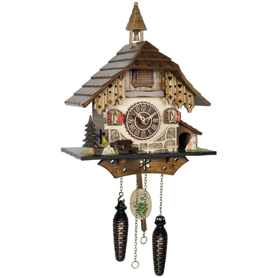 Wooden cuckoo clock with detailed design on a white background