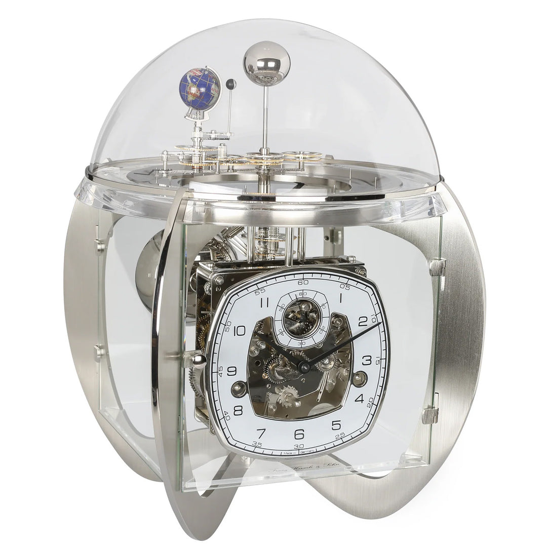 Mechanical nickel clock with transparent casing on a white background