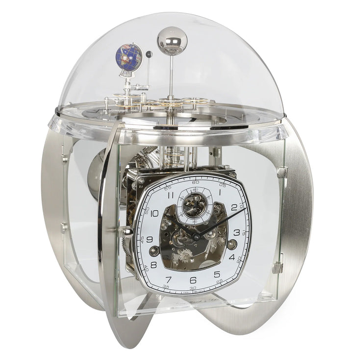 Mechanical nickel clock with transparent casing on a white background