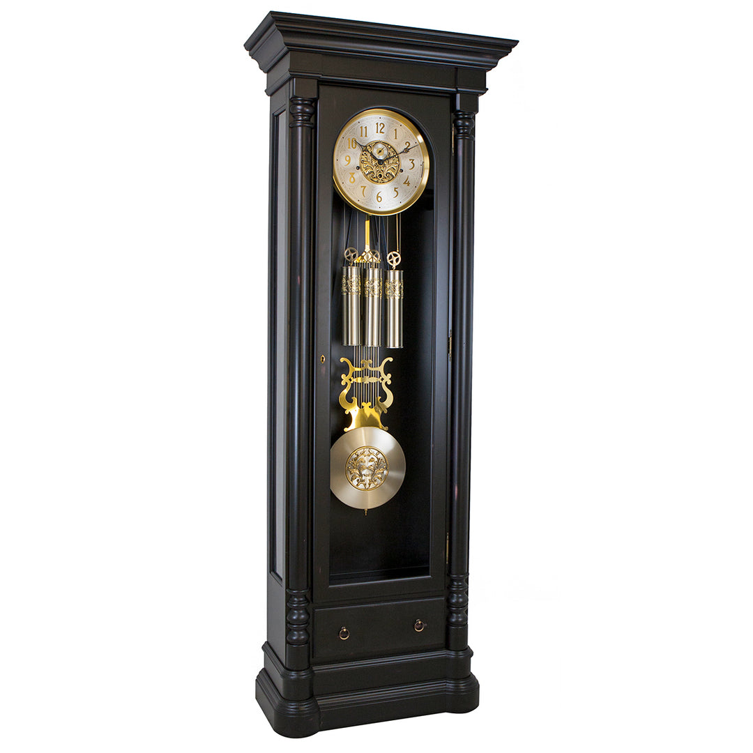 Black grandfather clock with gold accents on a white background