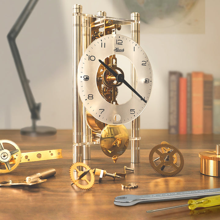 Lakin clock kit with clock parts sitting on desk with books and lamp in the background.