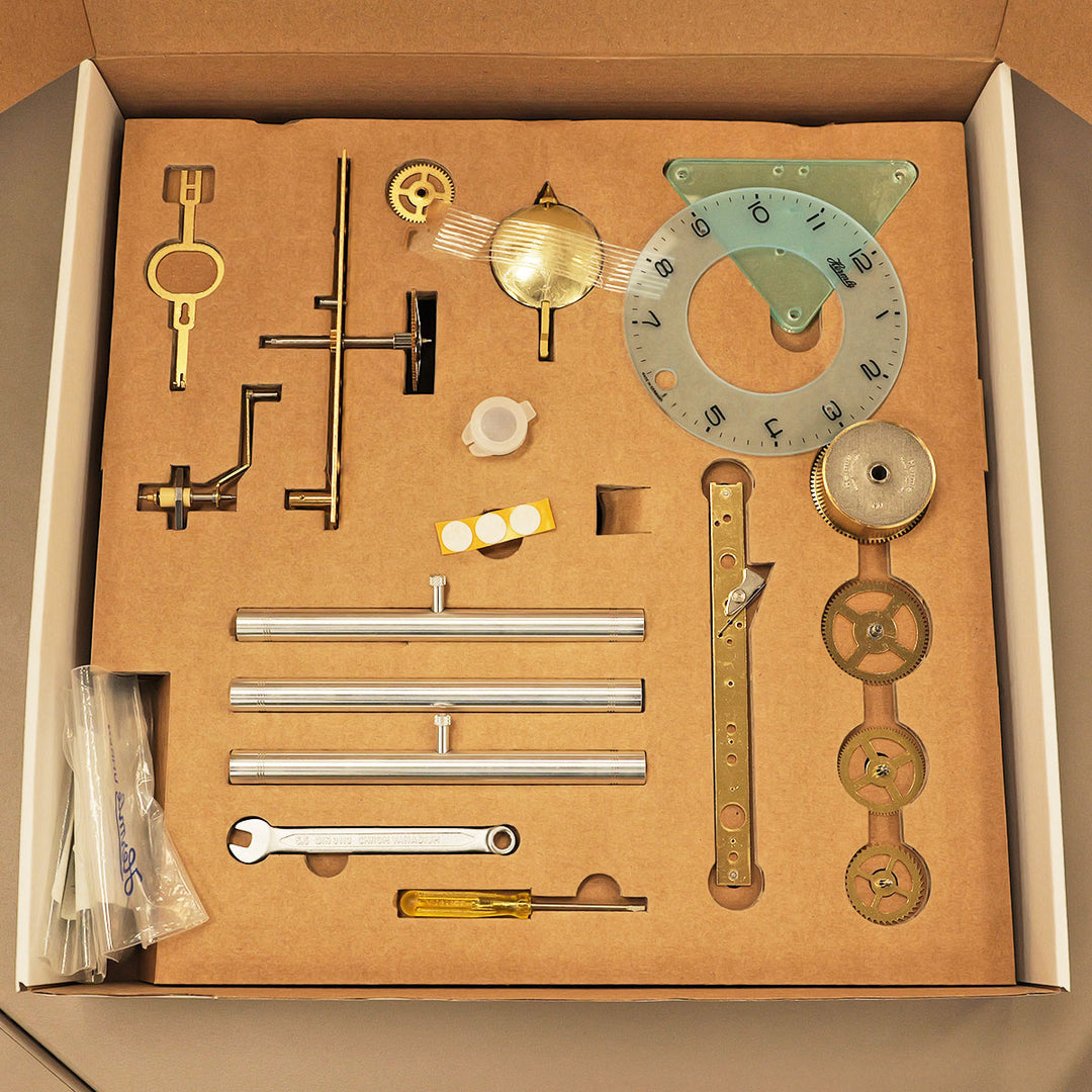 Lakin clock kit parts in cardboard box.