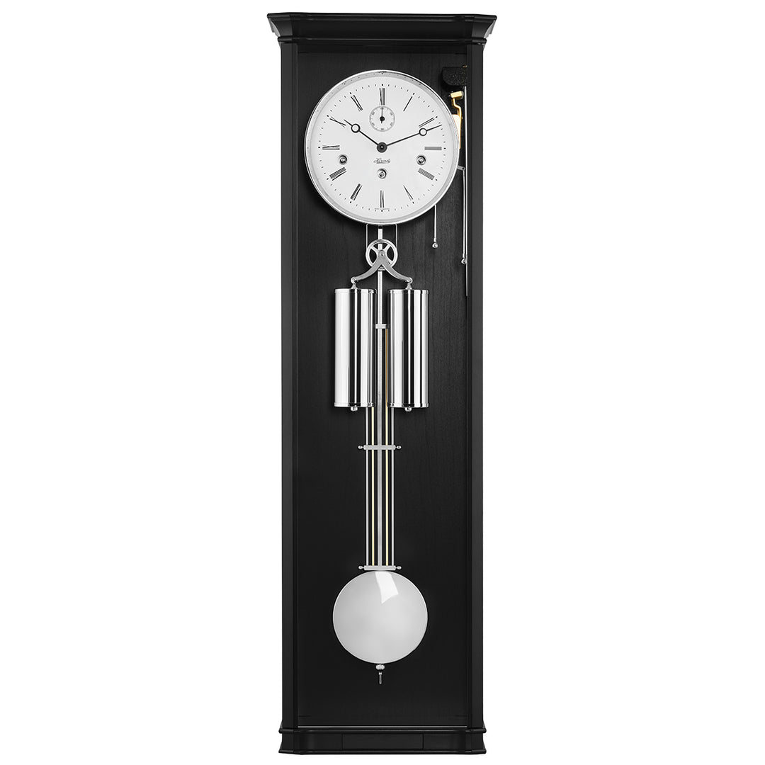Black wall clock with pendulum on a white background